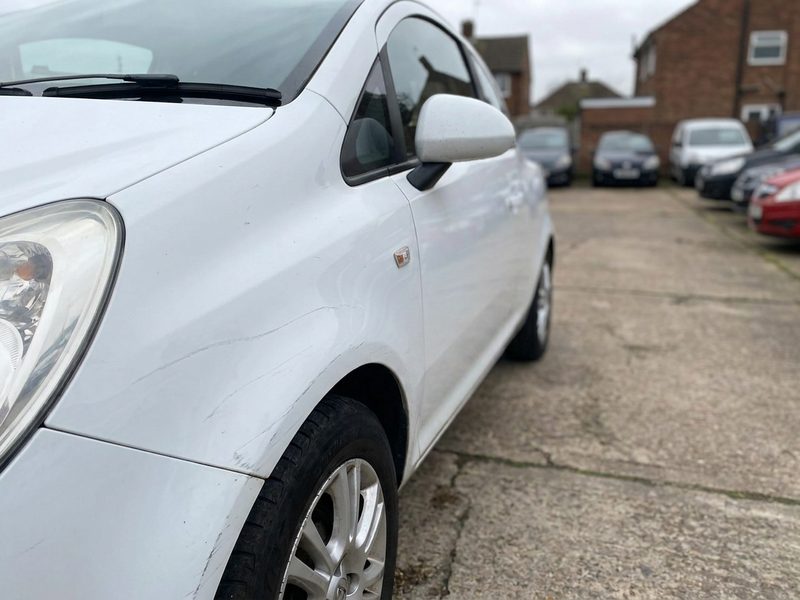 Scuffed white panel on forecourt stock before prep